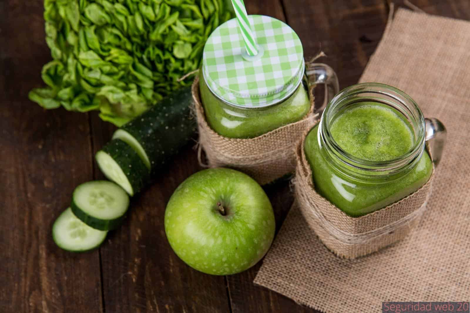 Green Apple Beside of Two Clear Glass Jars